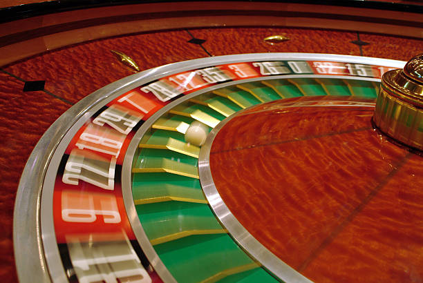 Live roulette wheel and live blackjack cards in studio setting